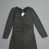 Black and gold textured dress against a light gray background